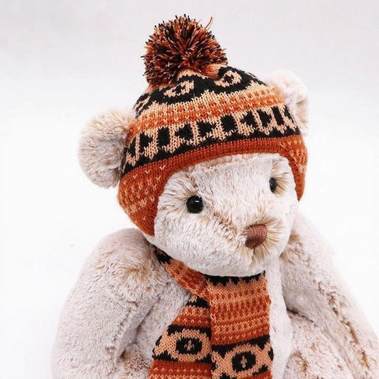 Cute British-style off-white short-haired teddy bear, wearing a knitted hat with pompom decoration and a knitted scarf in the same color