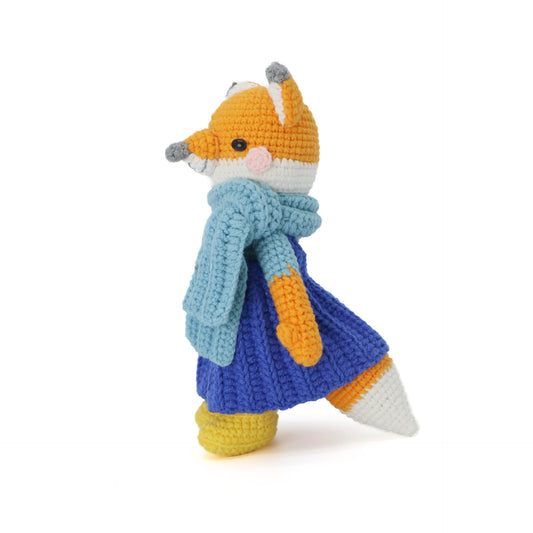 A handmade crocheted fox doll, featuring a light blue scarf paired with a dark blue skirt.It does not require glue, is made of pure cotton, feels soft, is safe and environmentally friendly, and is no problem for babies to bite.