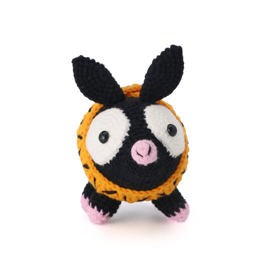 Hand-hooked black pig doll with orange and yellow scarf and pink hooves.It does not require glue, is made of pure cotton, feels soft, is safe and environmentally friendly, and is no problem for babies to bite.